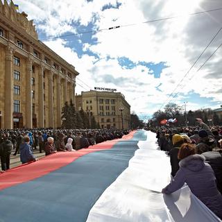 Un long drapeau russe a été déployé par les manifestants à Kharkiv. [EPA/SERGEY KOZLOV]
