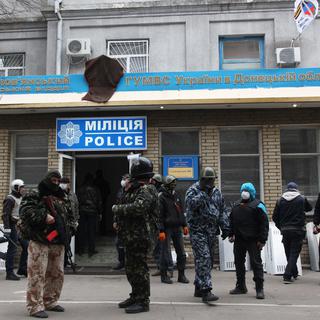 Des hommes armés, en tenue camouflage, cagoulés et armés se tenaient samedi à la mi-journée autour du commissariat de Slaviansk. [Anatoliy Stepanov]