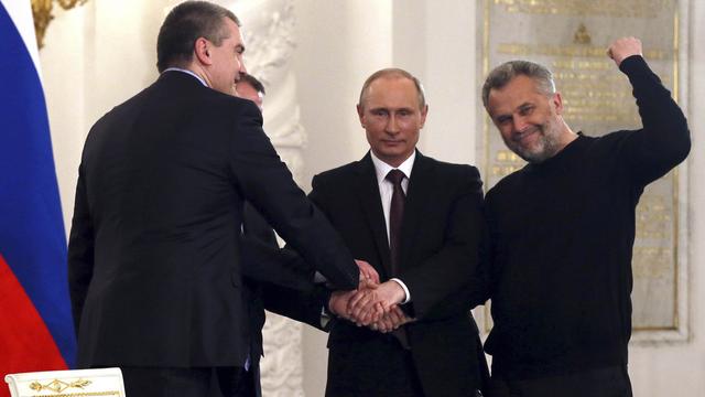 Vladimir Poutine a signé le traité intégrant la Crimée à la Russie. [AP Photo/Sergei Ilnitsky, Pool]