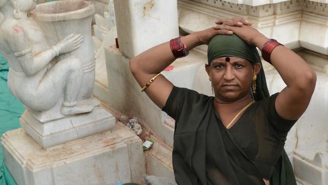 INDIA, Becharaji : An Indian transgender sits in the campus of Becharaji Temple some 110 kms from Ahmedabad where transgenders and eunuchs or hijras gather to worship Goddess Becharaji on April 15, 2014. India's highest court ruled Tuesday that a person can be legally recognised as gender-neutral, a landmark judgement that raises hopes of an end to discrimination against several million transgenders and eunuchs. AFP PHOTO / Sam PANTHAKY [Sam Panthaky]