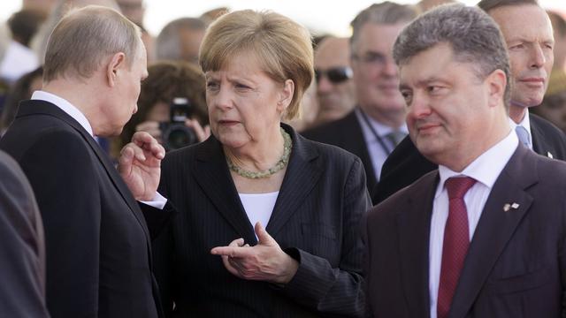 Vladimir Poutine, Angela Merkel et Petro Porochenko [SAUL LOEB]