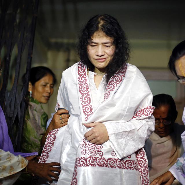 INDIA, Imphal : Indian rights activist Irom Sharmila (C), who has been on hunger strike for fourteen years, is greeted by her supporters following her release from a hospital jail in Imphal, India's northeastern Manipur state, on August 20, 2014. An Indian woman who has staged a 14-year hunger strike against rights abuses in the country's northeast broke down in tears as she was finally released from a hospital jail. AFP PHOTO/STR [AFP Photo]