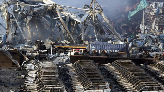 Des dizaines de véhicules ont été ravagés dans l'incendie. [AP Photo/Ng Han Guan]