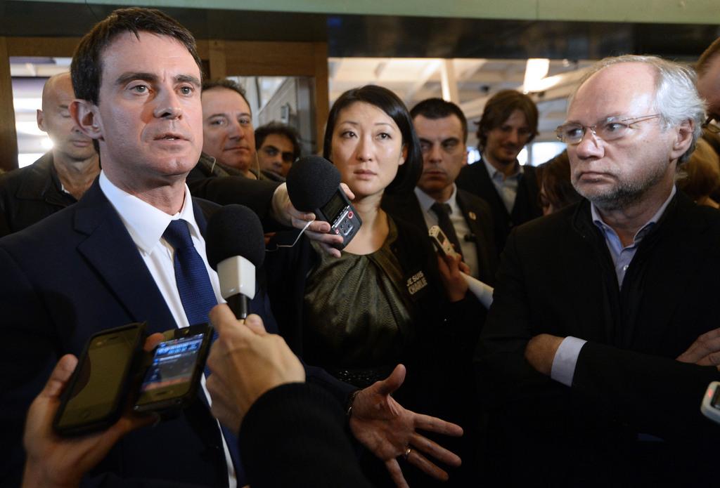 Manuel Valls (à gauche) et Fleur Pellerin (au centre) ont rendu visite aux journalistes de Charlie Hebdo. [Keystone - AP Photo/Bertrand Guay]