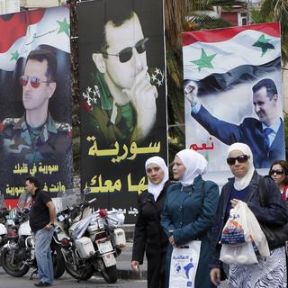 Des posters de soutien à Bachar al-Assad dans les rues de Damas. [Keystone - Khaled al-Hariri]