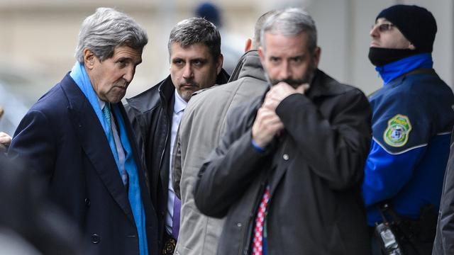 US Secretary of State John Kerry (L) arrives at his hotel on February 22, 2015 in Geneva. Kerry arrived in Geneva for renewed talks with his Iranian counterpart on Tehran's nuclear programme, after warning "significant gaps" remain as a key deadline approaches. Kerry is set to sit down for two days of talks with Iranian Foreign Minister Mohammad Javad Zarif, whose country denies its nuclear programme has military objectives. AFP PHOTO / FABRICE COFFRINI [AFP - FABRICE COFFRINI]