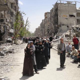 Quelque 18'000 civils, syriens et palestiniens, vivent encore dans le camp de Yarmouk (photographié ici en mai 2014). [Rame Alsayed]