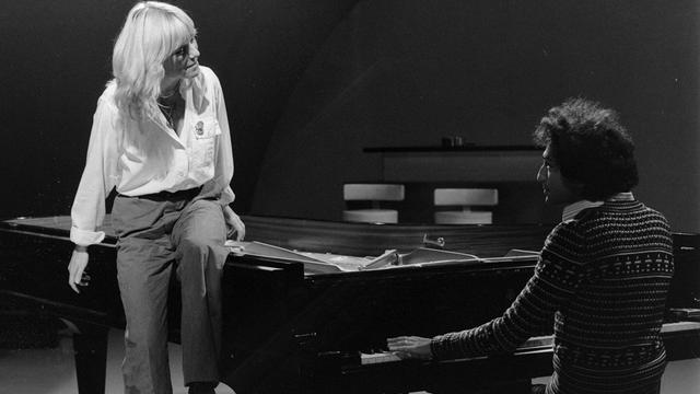 France Gall, presque debout, chante accompagnée au piano par Michel Berger, assis, dans l’émission de télévision Numéro 1, Paris 1er octobre 1976. [INA - Jean Pimentel]