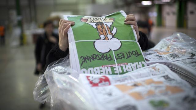 Le prophète Mohamet figure en Une de l'édition spéciale de Charlie Hebdo. [AFP - Martin Bureau]