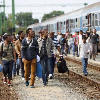 Des migrants à la frontière entre la Hongrie et l'Autriche. [Gyorgy Varga/MTI via AP]