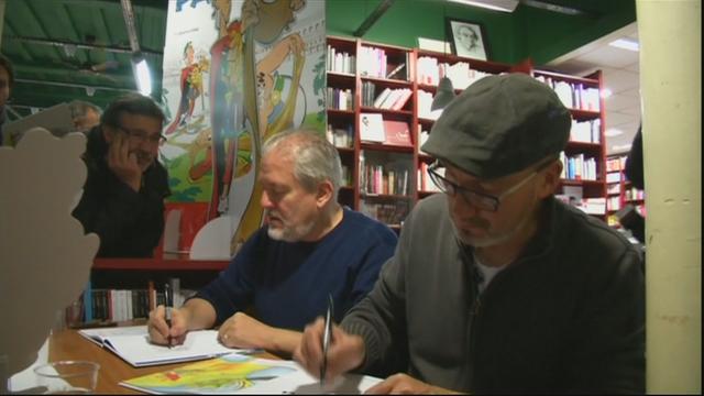 Séance de dédicaces dans une librairie du boulevard Saint-Germain, au coeur de Paris, avec le dessinateur Didier Conrad (gauche) et le scénariste Jean-Yves Ferri, tard mercredi soir.