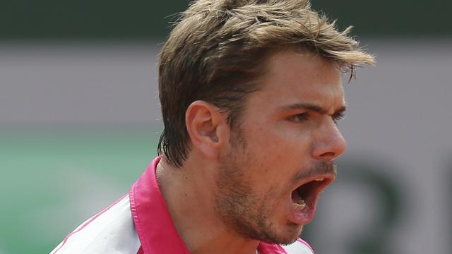 Switzerland's Stanislas Wawrinka clenches his fist after scoring a point in his third round match of the French Open tennis tournament against Steve Johnson of the U.S. at the Roland Garros stadium, in Paris, France, Friday, May 29, 2015. [AP Photo - David Vincent]