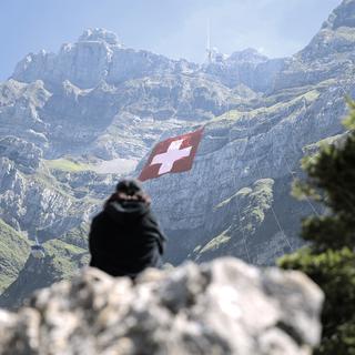 Les touristes apprécient toujours la Suisse malgré la cherté du franc, ici le drapeau suisse au Saentis pour la Fête nationale. [Pascal Bloch]