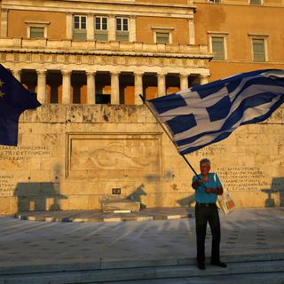 La Grèce a commencé à rembourser 6,25 milliards au FMI et à la BCE. [Keystone/AP - Petros Karadjias]