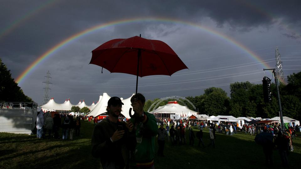 Festivaliers admirant un arc-en-ciel en 2007 à Paléo. [Denis Balibouse]