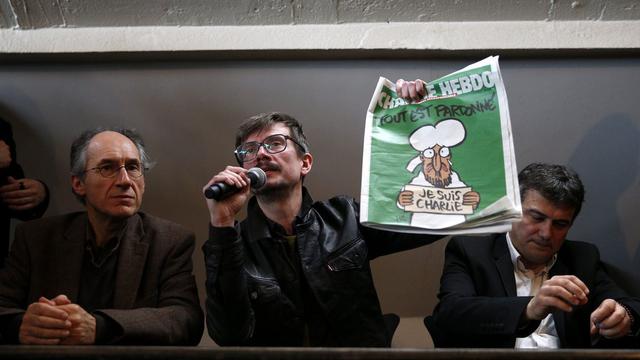 Le dessinateur Luz, qui a signé la Une, présente le dernier numéro de Charlie "Hebdo". [EPA/YOAN VALAT]