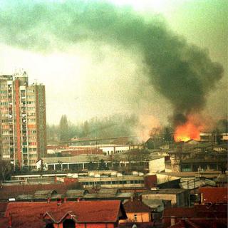 Le bombardement d'un baraquement militaire serbe à Pristina, actuelle capitale du Kosovo, le 25 mars 1999. [AP Photo/Keystone - Mikica Petrovic]