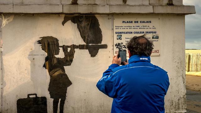 Une oeuvre de Banksy en hommage aux migrants sur un mur de Calais, en France. [AFP - Philippe Huguen]