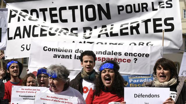 Contrairement à ces manifestants, le procureur estime que les accusés ne sont pas des lanceurs d'alerte. [AFP - John Thys]