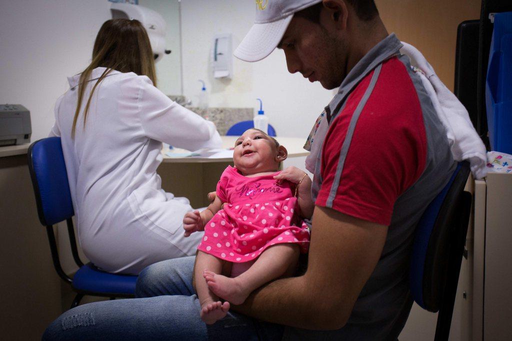 Un père et sa fille atteinte de microcéphalie, lors d'une consultation médicale à Recife au Brésil.