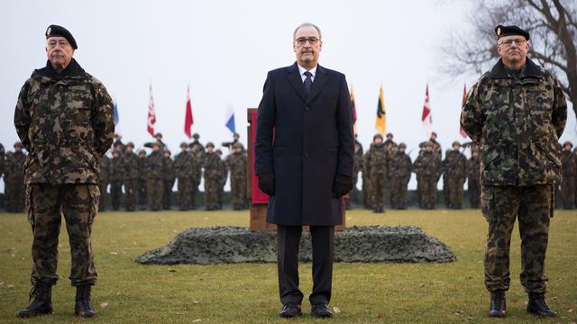 A gauche le commandant de corps André Blattmann, au centre le conseiller fédéral Guy Parmelin, et à droite le nouveau commandant Philippe Rebord. [KEYSTONE - Anthony Anex]