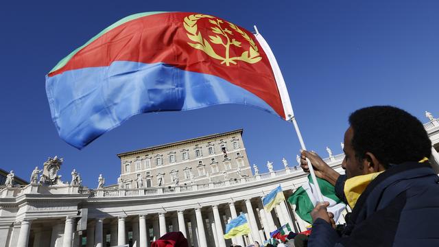 Un homme brandit un drapeau érythréen sur la place Saint-Pierre. [AP Photo/Alessandra Tarantino]