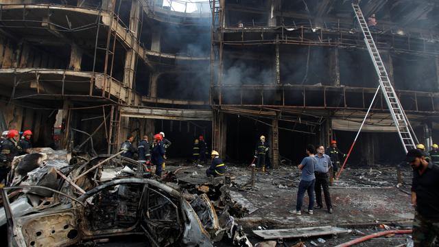 People gather at the site of a suicide car bomb in the Karrada shopping area, in Baghdad, Iraq July 3, 2016. REUTERS/Khalid al Mousily