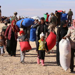 Réfugiés syriens passant la frontière jordanienne, 14.01.2016. [AP/Keystone - Raad Adayleh]