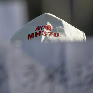 Un membre de la famille d'une personne disparue avec le vol MH370. [Damir Sagolj]