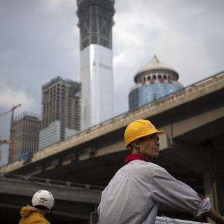 Les travailleurs migrants chinois doivent faire face à l'hostilité de Pékin. [Keystone/AP Photo - Mark Schiefelbein]
