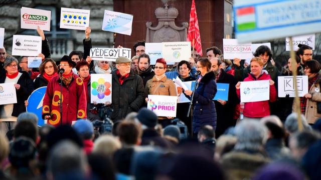 Des activistes de plusieurs ONG montrant leurs logos lors d'une manifestation contre le gouvernement devant le Parlement hongrois, le 5 février 2017. [AFP - Attila Kisbenedek]