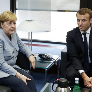 Angela Merkel et Emmanuel Macron jeudi à Bruxelles. [Pool/EPA/Keystone - François Lenoir]