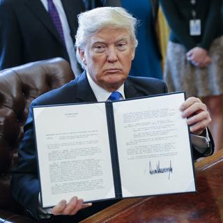 epa05747182 US President Donald Trump displays one of five executive orders he signed related to the oil pipeline industry in the oval office of the White House in Washington, DC, USA, 24 January 2017. US President Trump on 24 January 2017 signed an executive order that allows the disputed Dakota Access and Keystone XL pipelines, under the precondition that US-American steel was used. Former president Obama's administration in 2015 halted the controversial Keystopne XL project. EPA/SHAWN THEW [EPA - SHAWN THEW]