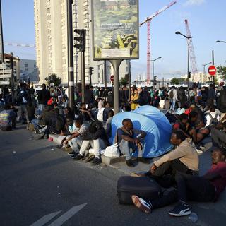 Des migrants rassemblés Porte de la Chapelle à Paris, juste avant le démantèlement du camp le 7 juillet 2017.