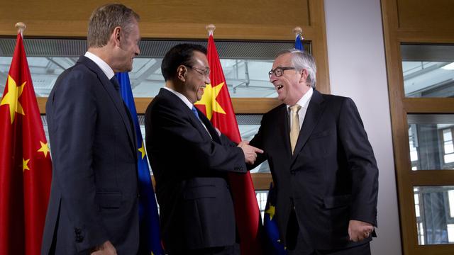 Les leaders européens Donald Tusk (à g.) et Jean-Claude Juncker entourant le Premier ministre chinois Li Keqiang lors d'un sommet des deux puissances sur le climat à Bruxelles. [AFP - Virginia Mayo]