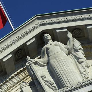 Le drapeau suisse et la statue de dame Justice du Tribunal fédéral (TF) à Lausanne. [Keystone - Laurent Gilliéron]