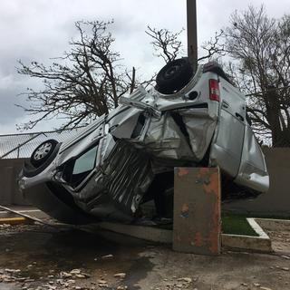 Une voiture retournée par l'ouragan Maria à Porto Rico. [Keystone - Jorge J. Muniz]