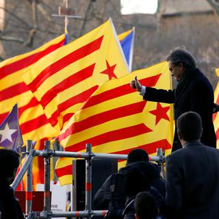 Former Catalan President Artur Mas and former regional councilors Joana Ortega and Irene Rigau gesture to a crowd of people waving Catalan Estelada flags as they arrived to court in Barcelona, Spain, February 6, 2017. REUTERS/Albert Gea [Reuters - Albert Gea]