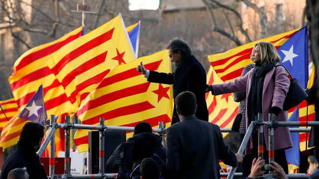 Former Catalan President Artur Mas and former regional councilors Joana Ortega and Irene Rigau gesture to a crowd of people waving Catalan Estelada flags as they arrived to court in Barcelona, Spain, February 6, 2017. REUTERS/Albert Gea [Reuters - Albert Gea]