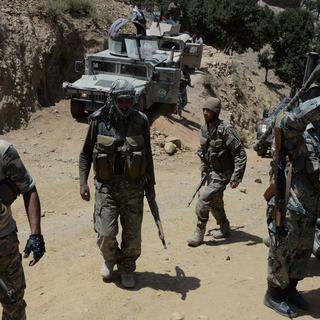 In this photograph taken on June 20, 2017, Afghan security personnel patrol during the ongoing offensive to retake Tora Bora in Pachir Aw Agam district, in Nangarhar province, that is held by the Islamic State (IS) group. IS fighters have captured Tora Bora, a mountain cave complex in eastern Afghanistan that was once the hideout of Osama bin Laden, despite pressure on the jihadists from US-led forces. [AFP - Noorullah Shirzada]