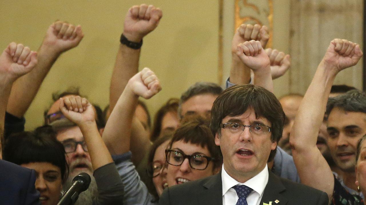 Le président du gouvernement catalan Carles Puigdemont chante l'hymne régional après le vote du Parlement sur l'indépendance. [Keystone - Manu Fernandez]