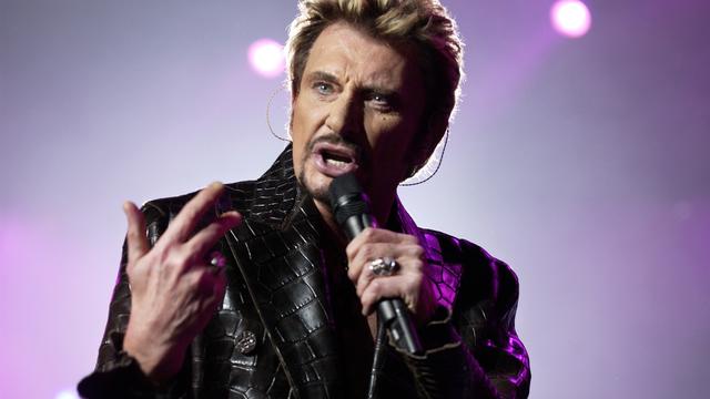 Johnny Hallyday lors d'un concert à Paris. [AFP - Bertrand Guay]