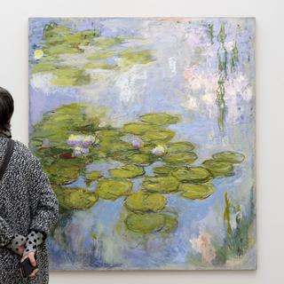 Une visiteuse devant "Les Nymphéas" de Claude Monet à la Fondation Beyeler, le 20 janvier 2017. [Keystone - Georgios Kefalas]