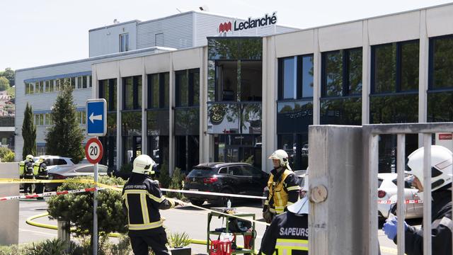 Des pompiers sur le site de l'usine Leclanché lundi. [Keystone - Jean-Christophe Bott]