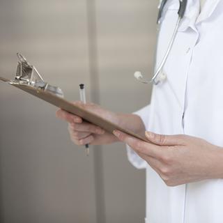 Doctor scrutinizing medical chart, cropped 
Frédéric Cirou / AltoPress / PhotoAlto [PhotoAlto]