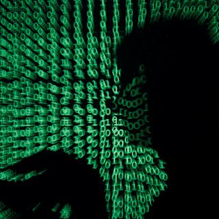 DATE IMPORTED:May 13, 2017A man holds a laptop computer as cyber code is projected on him in this illustration picture taken on May 13, 2017. Capitalizing on spying tools believed to have been developed by the U.S. National Security Agency, hackers staged a cyber assault with a self-spreading malware that has infected tens of thousands of computers in nearly 100 countries. REUTERS/Kacper Pempel/Illustrati