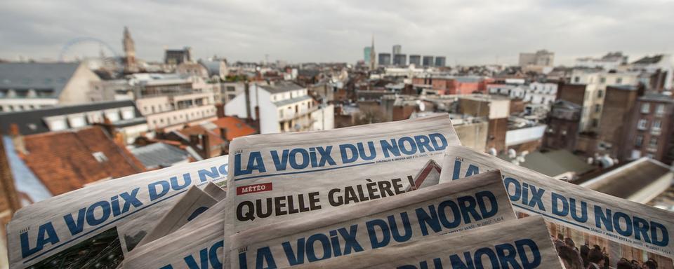 Le journal français La Voix du Nord avec en arrière fond la ville de Lille. [AFP - Philippe Huguen]