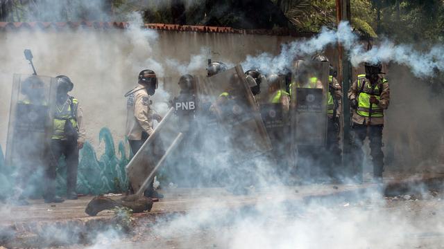 La garde nationale a fait usage de gaz lacrymogènes et balles en caoutchouc pour disperser les étudiants vénézuéliens dont certains répondaient avec des pierres et des cocktails Molotov. [FEDERICO PARRA]