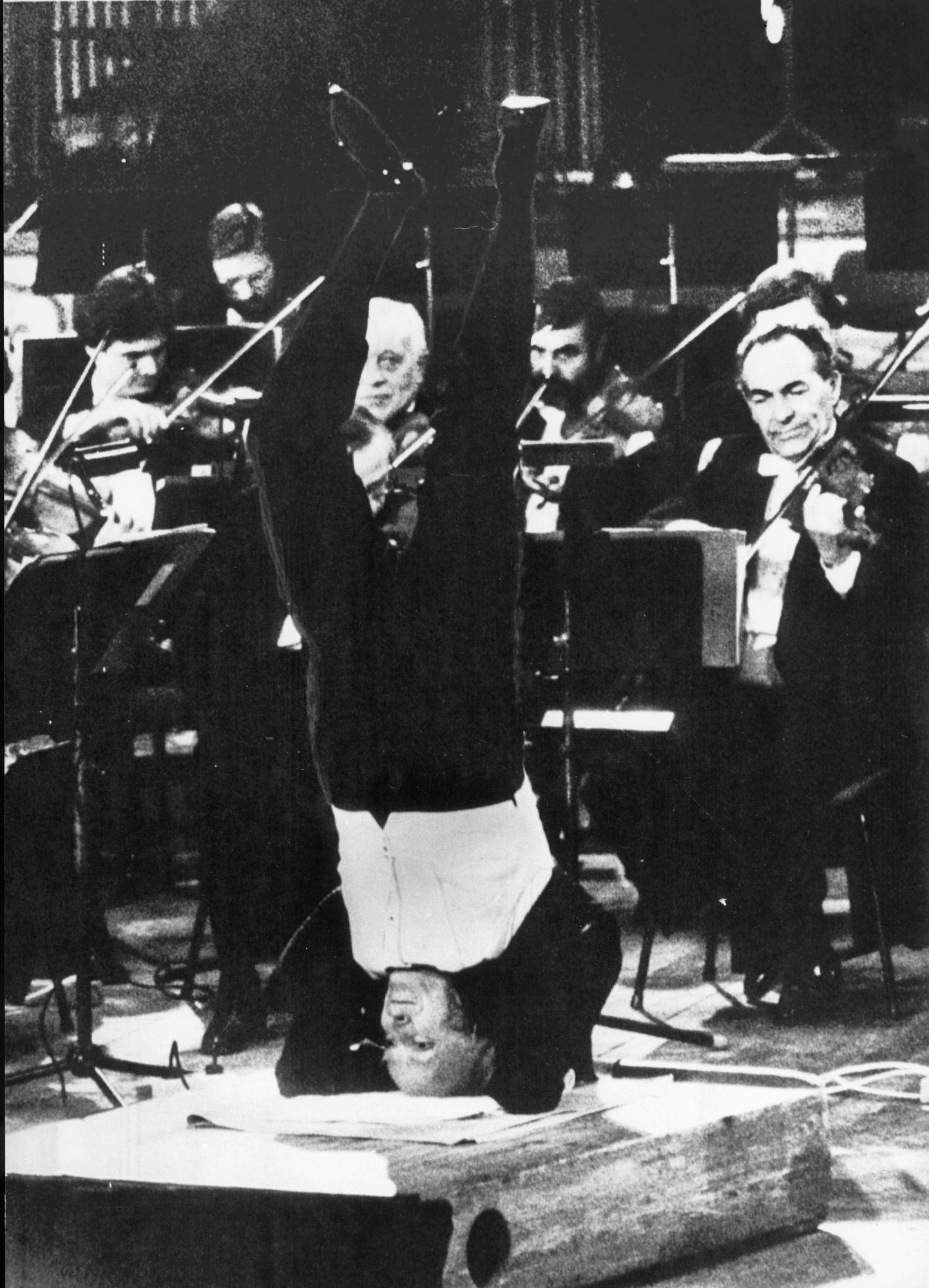 Yehudi Menuhin dans un position de yoga, dirige le Philharmonique de Berlin avec les pieds en mai 1982. [AFP]