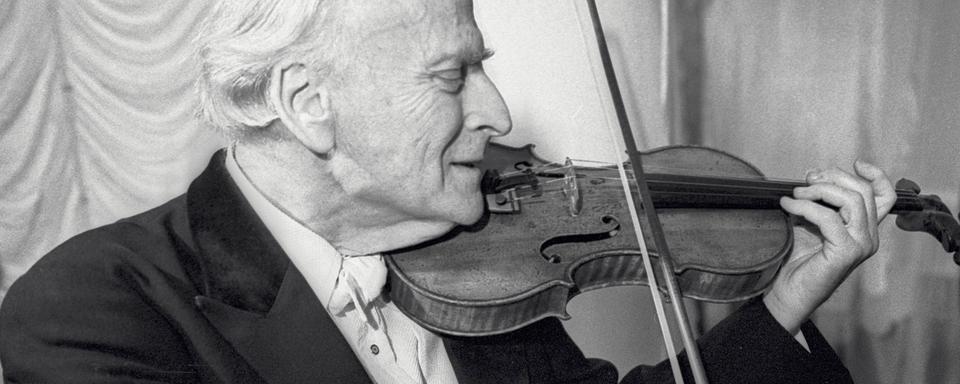 Yehudi Menuhin accordant son violon juste avant un concert en 1987. [AFP - Sekretarev / RIA Novosti / Sputnik]